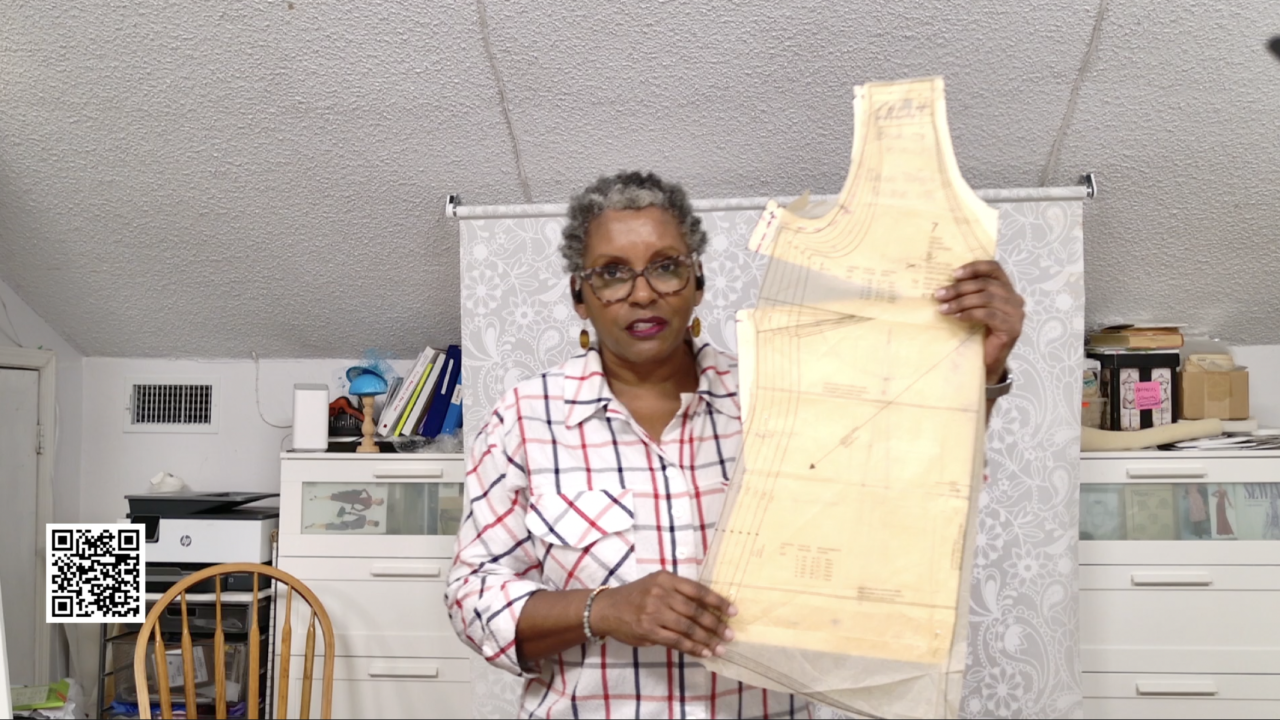 Andrea holding a pattern for a tank top and a matching block pattern design